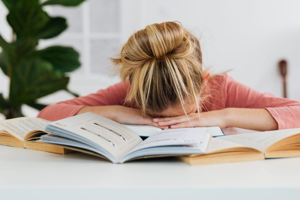 burn out scolaire. enfant allongé sur on livre